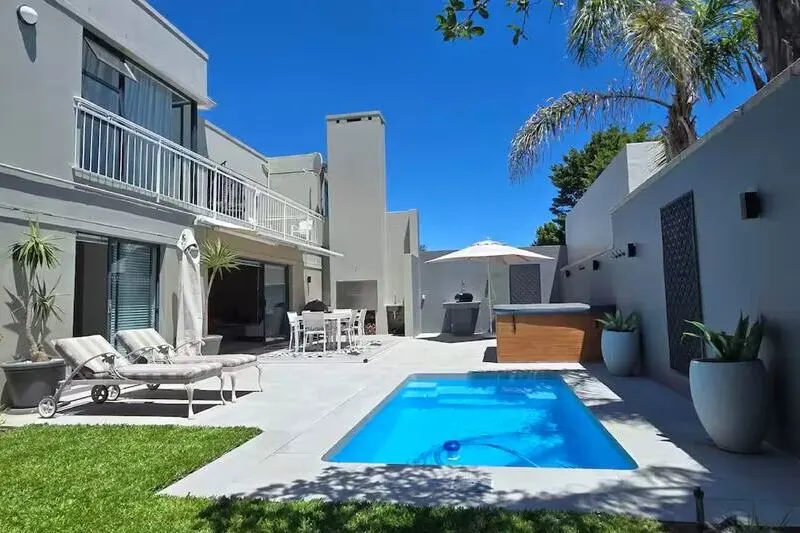 luxury main bedroom in cape town villa with queen sized bed and en-suite bathroom with modern interior