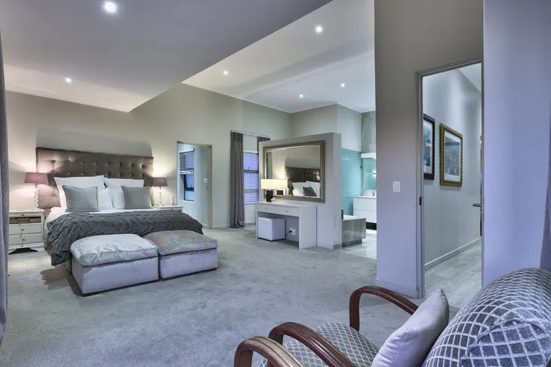 luxury main bedroom in cape town villa with queen sized bed and en-suite bathroom with modern interior